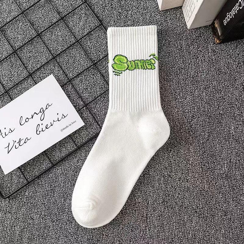 White ribbed crew sock with green graphic text, cotton material, streetwear style.