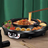 Electric hot pot grill combo with noodles, beef, seafood, and vegetables on a wooden table