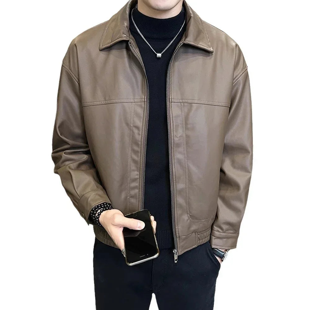 Man wearing a brown faux leather bomber jacket with relaxed fit, black turtleneck, and black pants