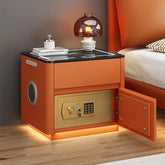Modern orange nightstand with black glass top, built-in speaker, and open gold safe