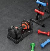 Adjustable black and orange dumbbell set with colorful neoprene hand weights on gym floor
