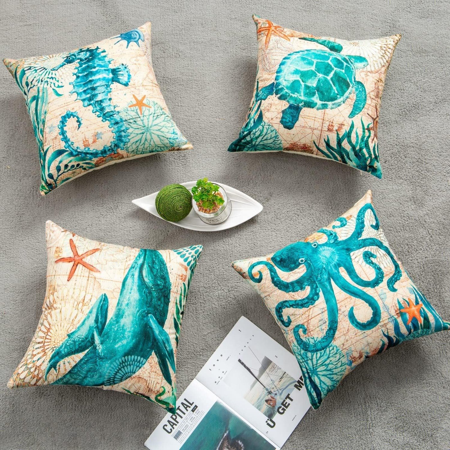 Set of four decorative throw pillows with blue sea animal prints, cotton linen material, square shape, on grey carpet