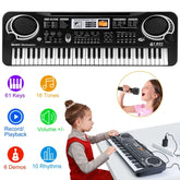 Girl in red sleeveless dress over gray turtleneck playing a black electronic keyboard, modern casual fit.