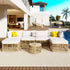 Modern outdoor patio set with beige rattan frame, white cushions, yellow pillows, and round table