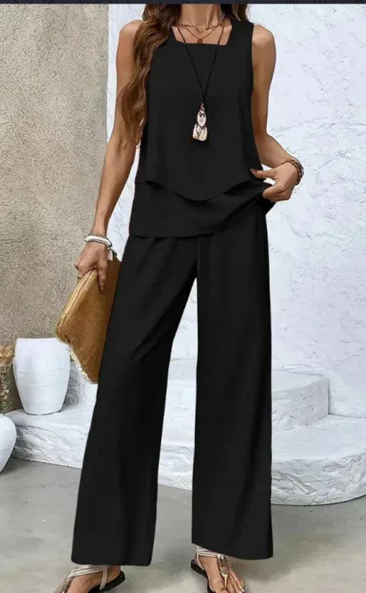 Woman wearing black sleeveless loose-fit two-piece pants set, lightweight flowy fabric