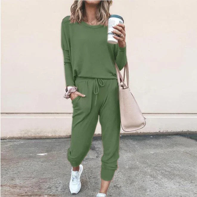 Woman wearing casual green jogger set with drawstring waist, relaxed fit, and white sneakers