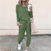 Woman wearing casual green jogger set with drawstring waist, relaxed fit, and white sneakers