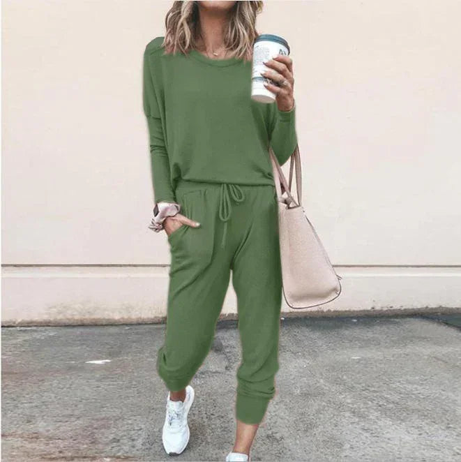 Woman wearing casual green jogger set with drawstring waist, relaxed fit, and white sneakers