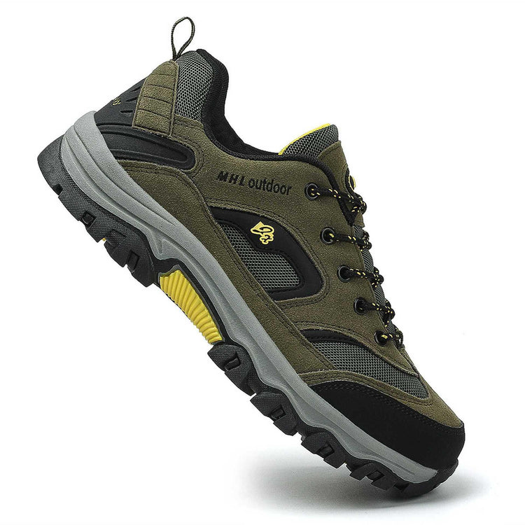 Olive green and black outdoor sneaker with mesh panels, chunky sole, and yellow accents