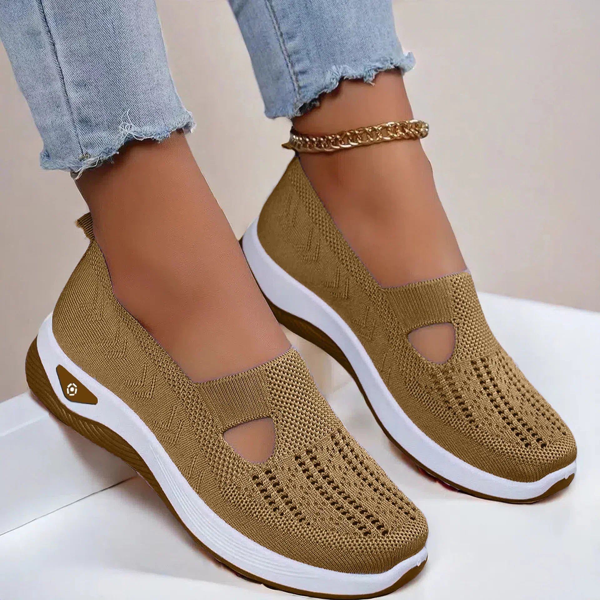 Light brown knit slip-on sneakers with white soles, perforated design, casual fit