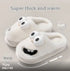 White plush slippers with cartoon face, thick soft material, cozy slip-on fit.