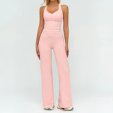 Woman wearing light pink fitted tank top and wide-leg pants, stretchy activewear set