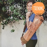 Woman carrying handcrafted OM Sutra yoga bag with embroidered cotton fabric and bohemian design outdoors